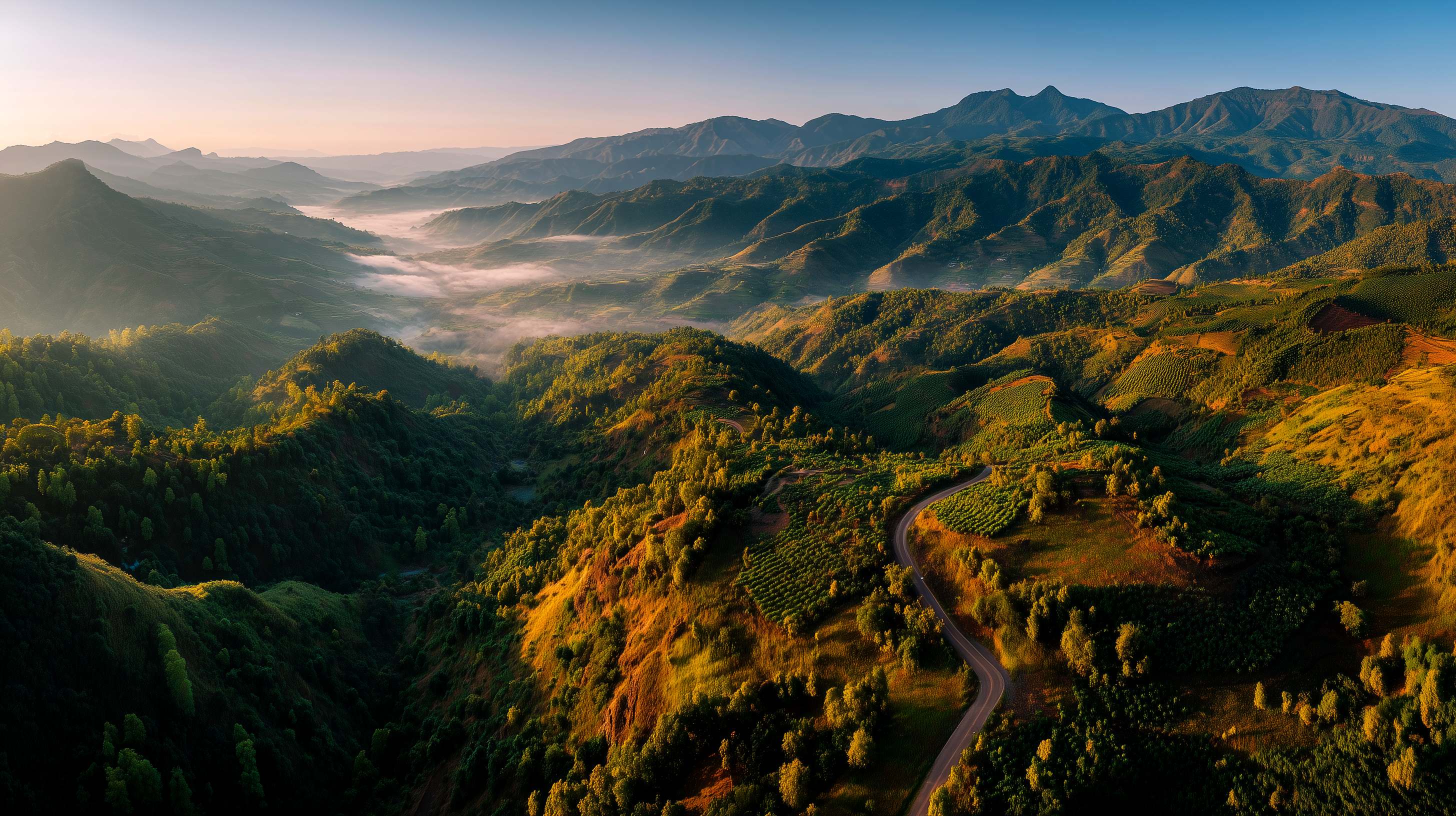Mountain farmland at sunrise across open agricultural land